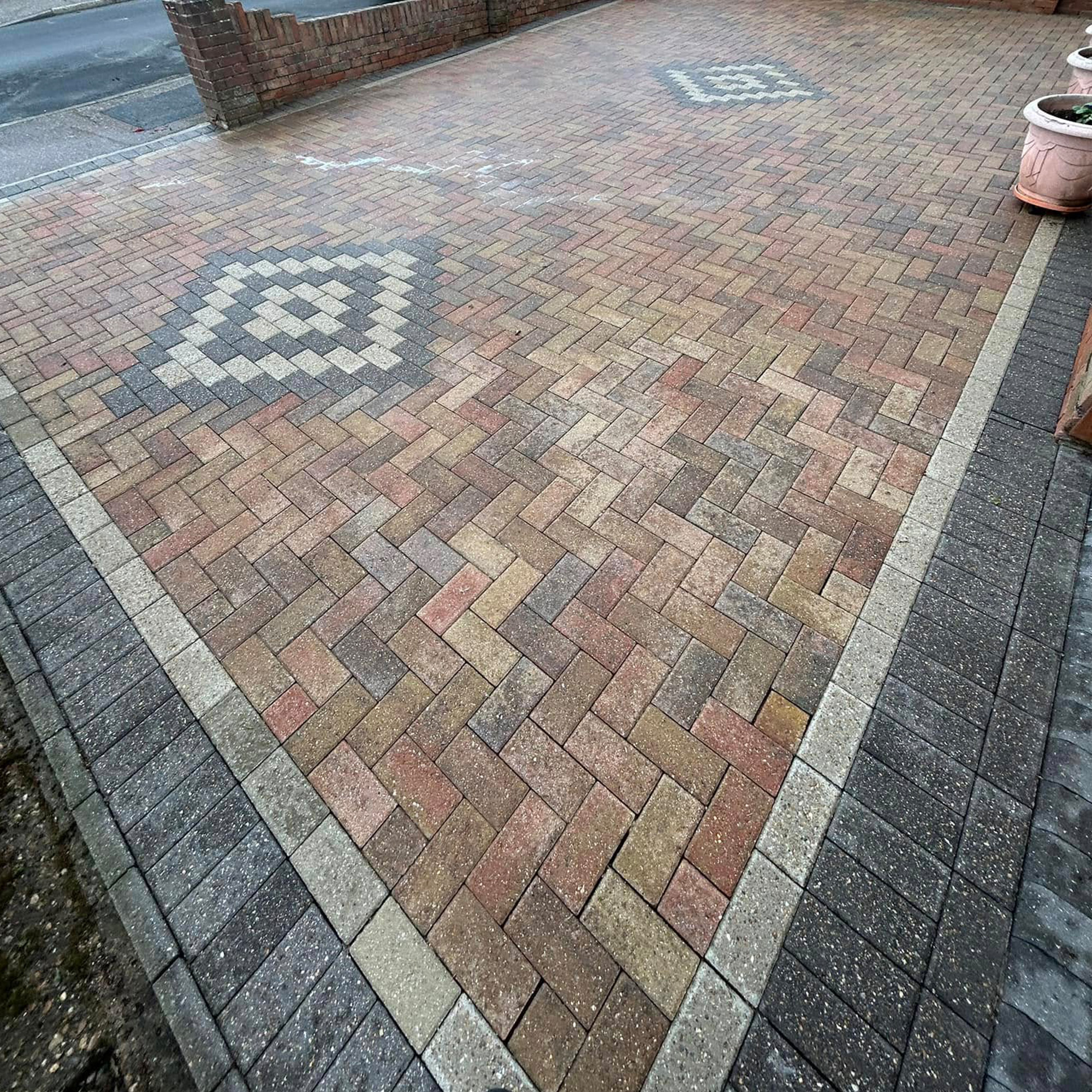 Driveway after restoration - beautiful restored block paving with decorative pattern